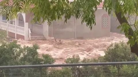 Floods trap people in cars in Spain’s Catalonia region